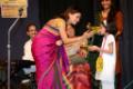 Kadambari distributing prizes to small student of Meera music classes.