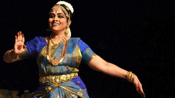 Revathi S. performing on stage.
