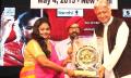 Deepak Vora presenting award to Anuja Sinha Bisaria