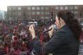 Suhasini performing in front of audience at holi celibration.