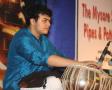 Mihir playing tabla in a concert